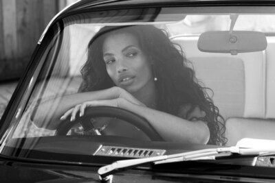 Bride sitting in a classic car outside a wedding venue in London