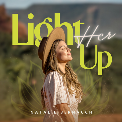Smartphone screen displaying “Light Her Up” podcast by Natalie Bernacchi, featuring Natalie smiling in a desert backdrop