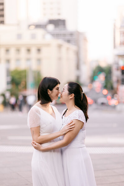 Same-sex couple walking through Brisbane City after their registry wedding — joyful and modern Brisbane registry marriage photography.