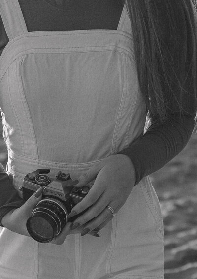 Photographer branding photos holding vintage camera