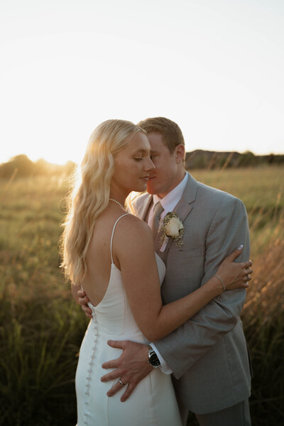 Bride and Groom walk alongside shoreline