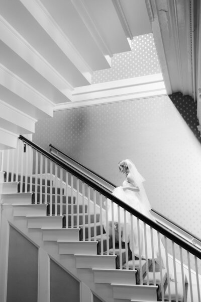 A bride walking the stairs at Waverley country club wedding