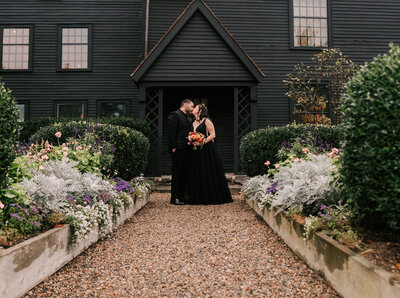 goth alternative couple kissing at their intimate wedding in Salem, Massachusetts