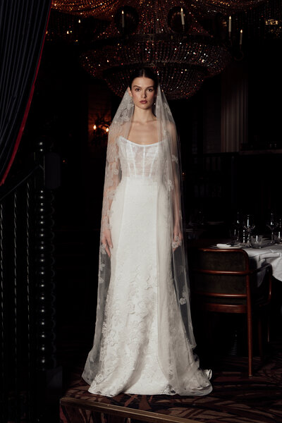 black and white image bride wearing feathered wedding dress