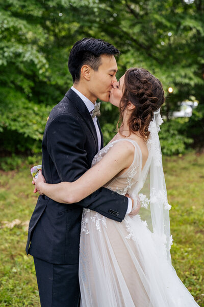 Bride and groom kiss in the rain Hillsborough, NC