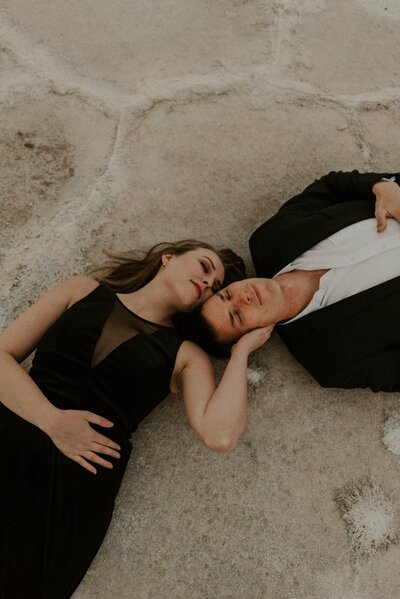Couple laying on the ground in the desert