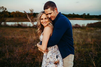maternity mom dressed in a beautiful mauve two piece dress posing at Paula Goforth studio in Fort Worth 