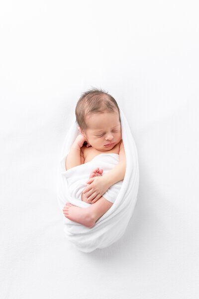 Swaddled newborn portrait in monogram blanket for Savannah, GA photography session