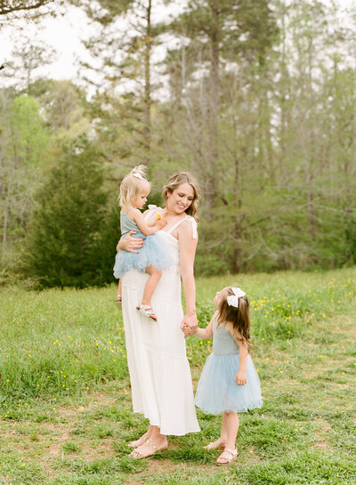 Mom holds and laughs with her 3 kids during a Raleigh Family Photographer session. Photographed by Raleigh Family Photographer A.J. Dunlap Photography.