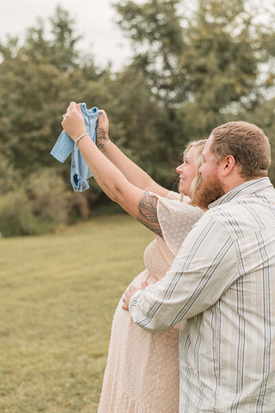 Bride and groom share a first look  on a wooden dock by a forest lake at a southwestern Pennsylvania wedding venue