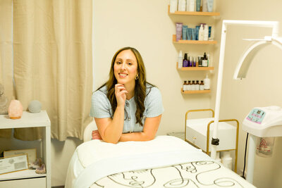 Cindy smiling at camera in her skincare studio