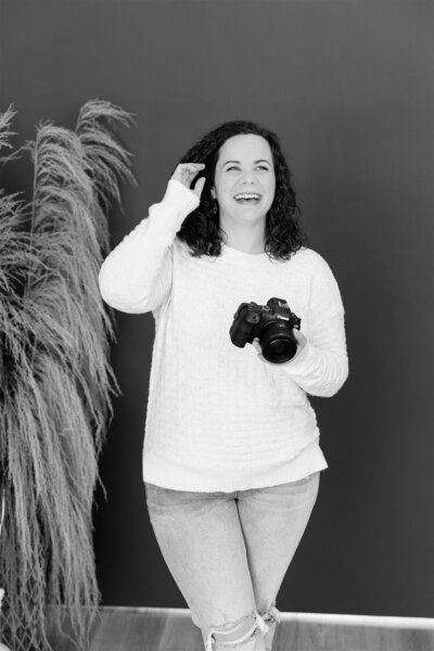 Colorado Springs Boudoir Photographer laughing with camera in hand