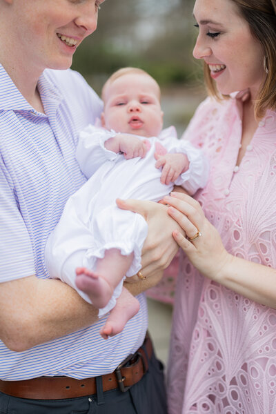 Parents holding baby during newborn photo session in Birmingham