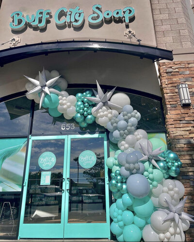 Large organic balloon garland at a business entrance for a grand opening by Loononna, LLC in Orlando, FL.