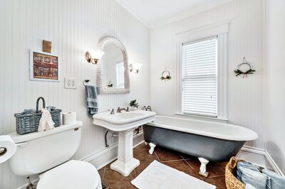 Claw foot tub in one of four bathrooms in this historic vacation rental home in downtown Waco, TX