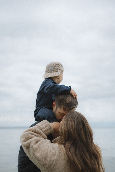 Irvine family photography session by the ocean, capturing a natural, playful connection between parents and child.