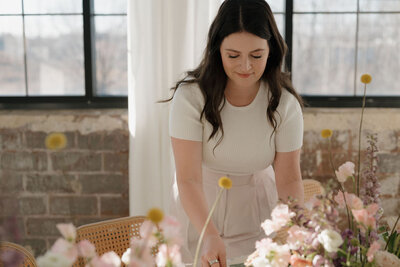 milwaukee event planners dressed nicely arranging a gorgeous floral table design.