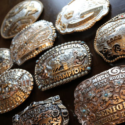 Gold cowboy buckles laying on a table