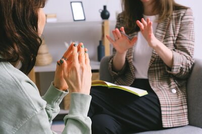 two women sitting meeting talking