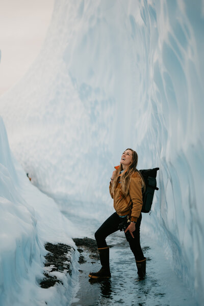 woman standing in glacier crevasse