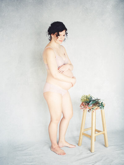 pregnant mom with flowers in asheville studio