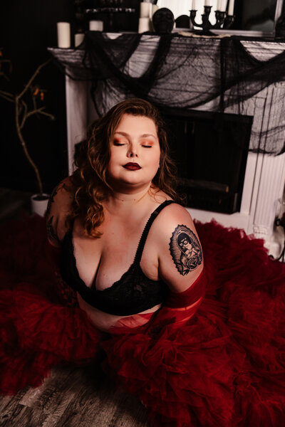 a girl wearing a red robe boudoir by shan - orlando boudoir photographer