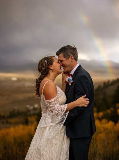 Couple at the beach during their wedding photoshoot smiling