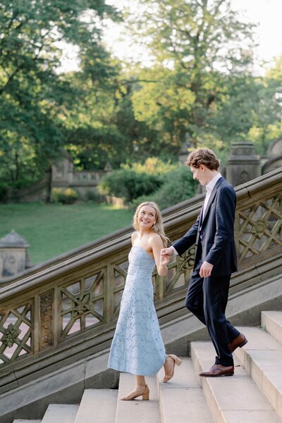 engaged couple walking down steps near Central Park