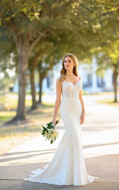 LACE AND CREPE WEDDING DRESS WITH STATEMENT BACK An absolutely striking piece, Style 1294 from Martina Liana is for brides who are all about the details. This relaxed fit-and-flare silhouette features a soft sweetheart plunge and off-shoulder neckline for an elegant and universally flattering shape. Classic beading and exquisite laces are incorporated throughout the sheer bodice for a hint of shimmer, reaching over the sides of the hips and midsection to elongate the frame and sculpt the figure. A scoop back features a tattoo lace effect with illusion tulle and gorgeous floating laces, while the stunning organic-edged train is artfully finished.