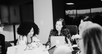 Erika facilitating a group conversation during a business retreat