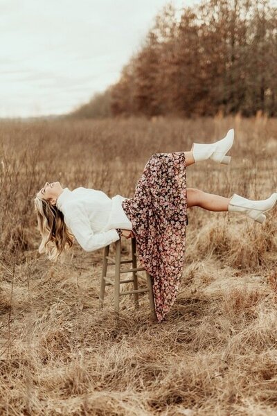 Girl-laying-back-on-a-stool-with-her-hair-laying-out-legs-up-in-the-air