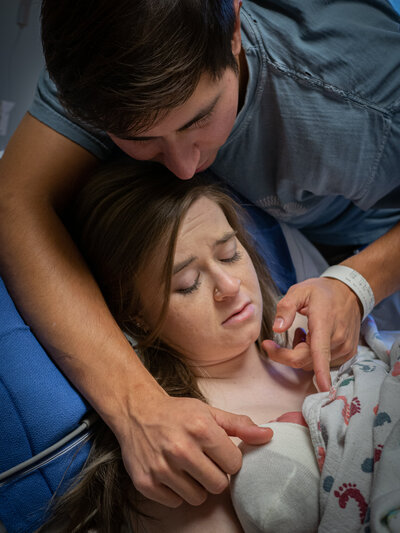 a mother holds her baby for the first time after giving birth.