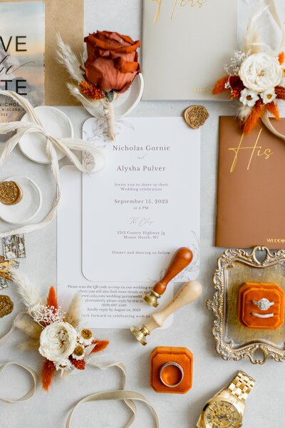 Close up of bride delicately holding a gold tone Valentino perfume bottle