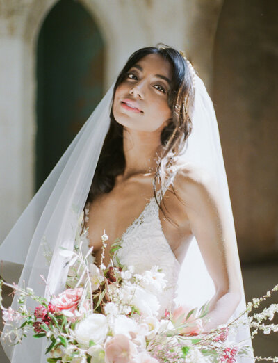 beautiful Indian bride in white wedding dress and veil, destination film wedding photographer in Croatia
