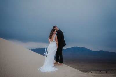A bride and groom walk up the aisle after getting married, being showered in flower petals.