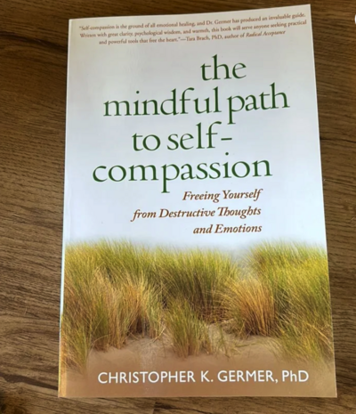 The Mindful Path to Self Compassion book sitting on a table