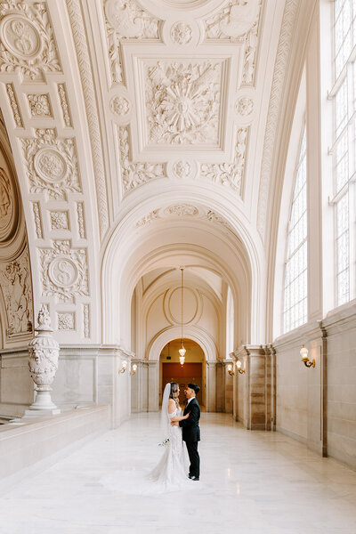 newlyweds walk up grand staircase