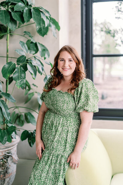 Headshot of Kelsey in a green floral dress