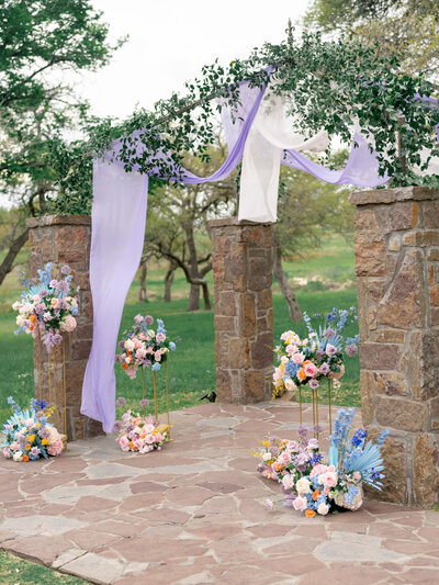 stone ceremony feature with florals