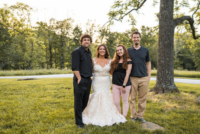 Photographers smile with newly married couple on wedding day