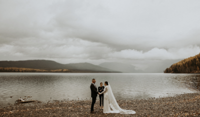 bride and groom holding hands during outdoor elopement in glacier national park