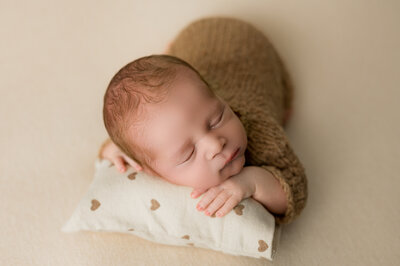 Newborn Boy on Neutral Toned Backdrop in North Dakota Newborn Studio