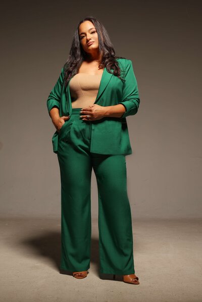 Owner of Tinted Events in a power pose with one hand in her pocket and the other around her waist