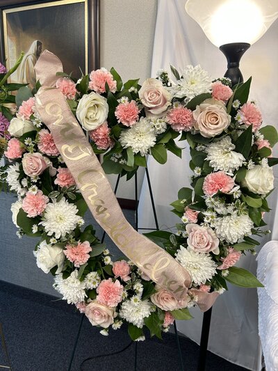 bride and groom kissing outside LDS temple bride holding light pink roes bouquet