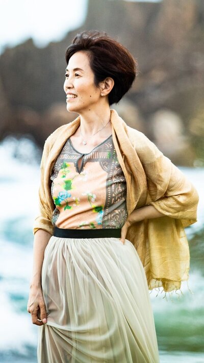 Outdoor lifestyle brand portrait of founder in casual dress against natural landscape