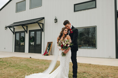 Bride and groom stand in front of their wedding venue