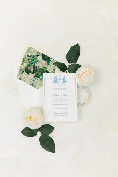 A classic, elegant semi custom wedding invitation suite in blue and white with a hydrangea monogram crest for a Washington DC wedding.