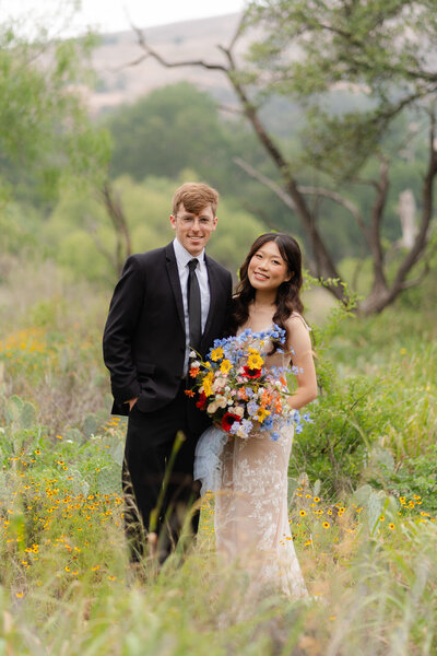 couple snuggling and holding hands after their elopement