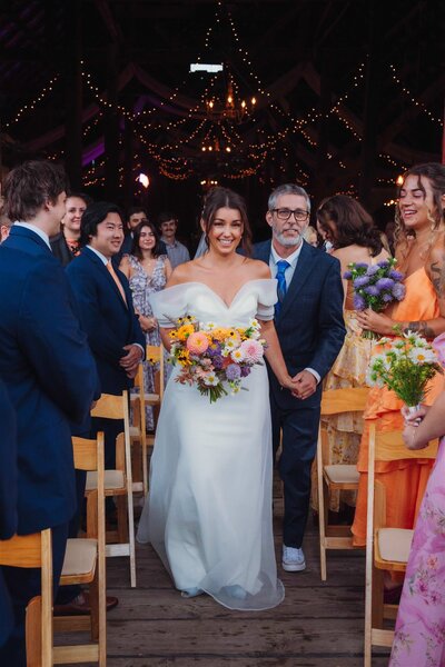 An engaged couple sitting in an archway at Bard College's Blithewood Garden in upstate NY