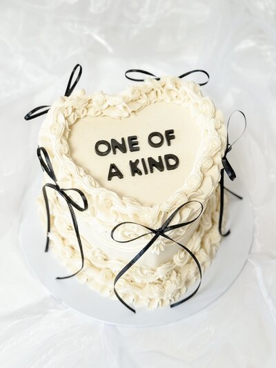 White vintage heart wedding cake in white buttercream with black Mr & Mrs initials